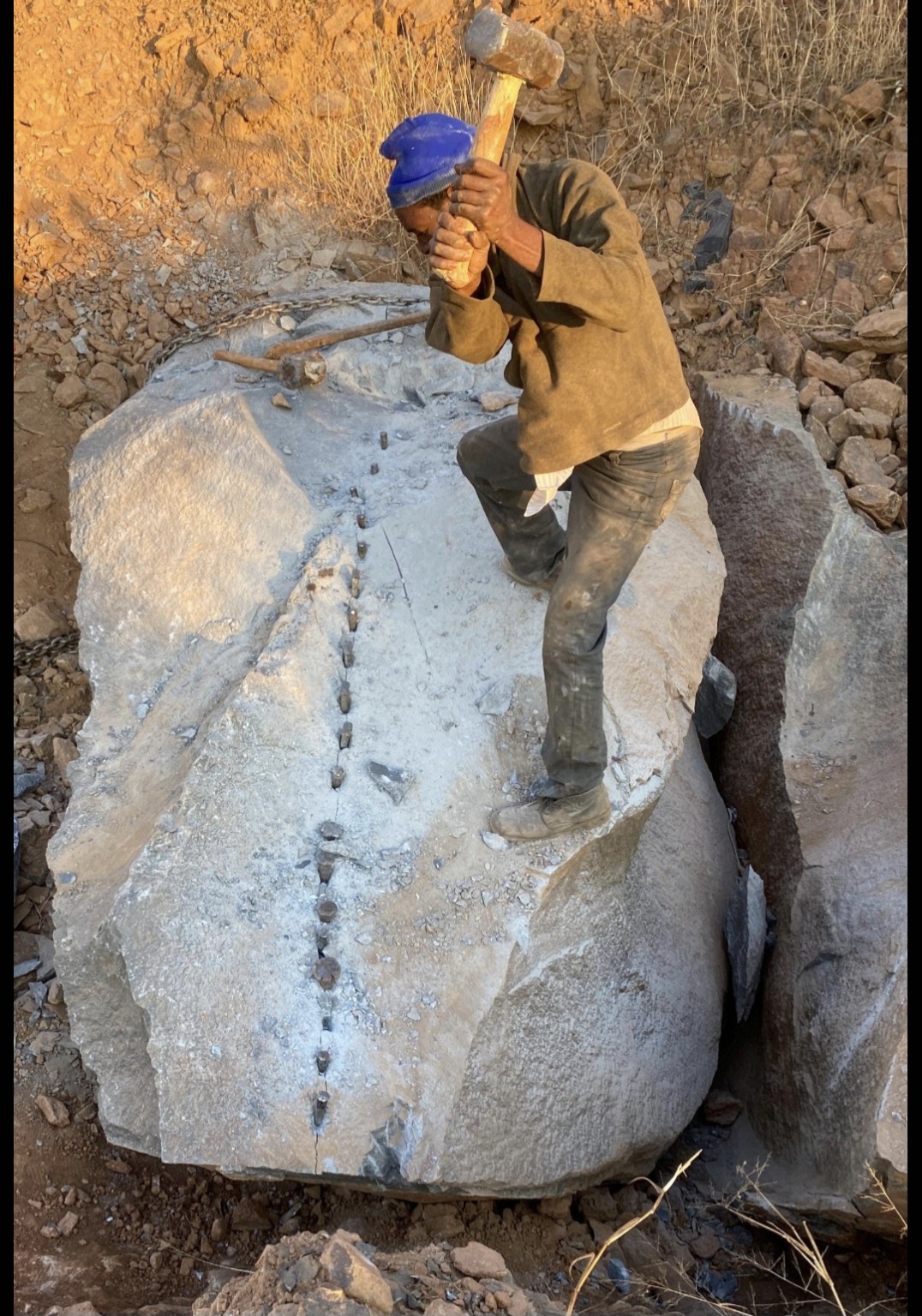 Stone being carefully split by hand at a Zimbabwean quarry